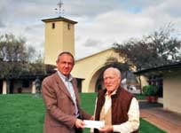 Image: Stephen Skelton receiving his award from Robert Mondavi  in 2003 in front of a Southern European style building or church